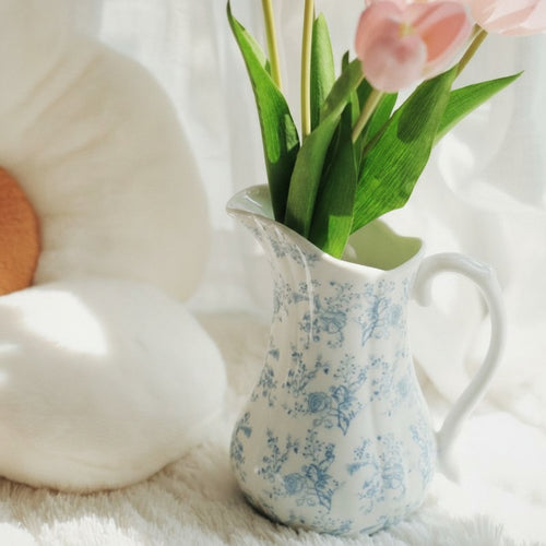Blue and white porcelain pitcher vase with pink tulips