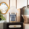 Blue and white porcelain table lamp on bedside table