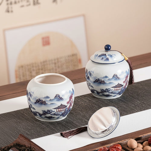 Open blue and white porcelain tea jar showing foil-lined lid