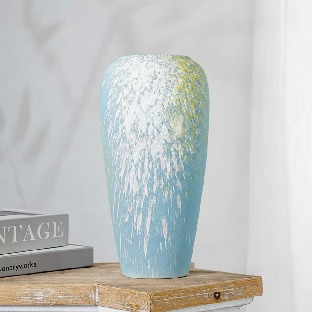 Blue and white splattered ceramic vase on wooden table
