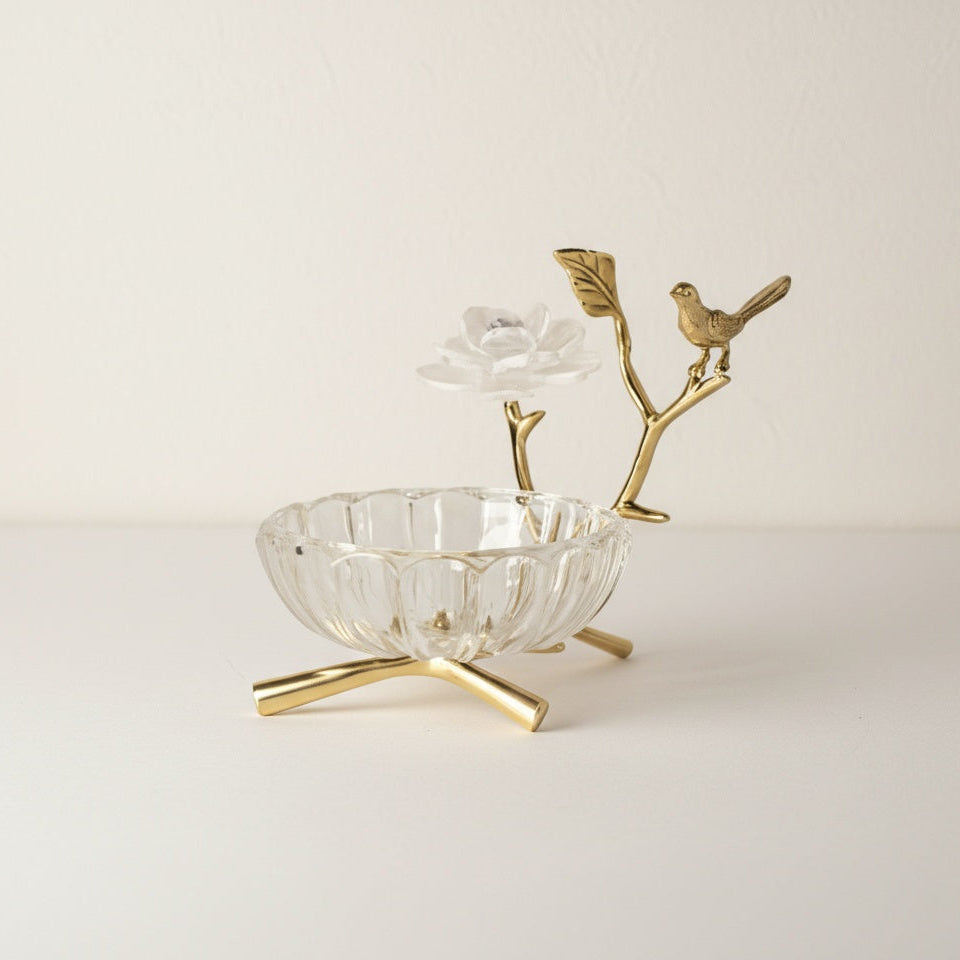 Studio shot of empty brass and crystal bird bowl isolated on white