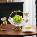 Brass and crystal glass fruit basket with butterfly handle on table