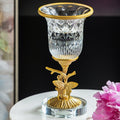 Close up of crystal vase on brass butterfly stand