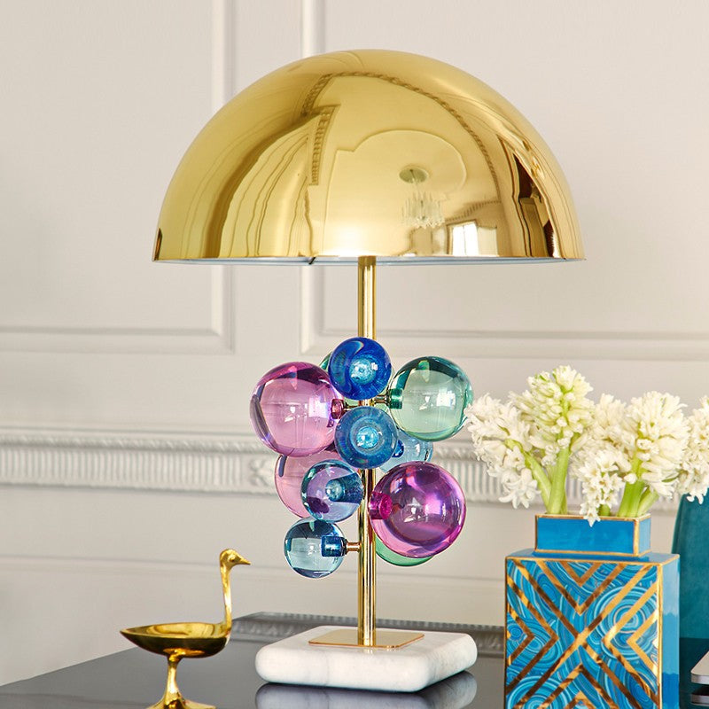 Detail of colorful glass spheres and marble base on table