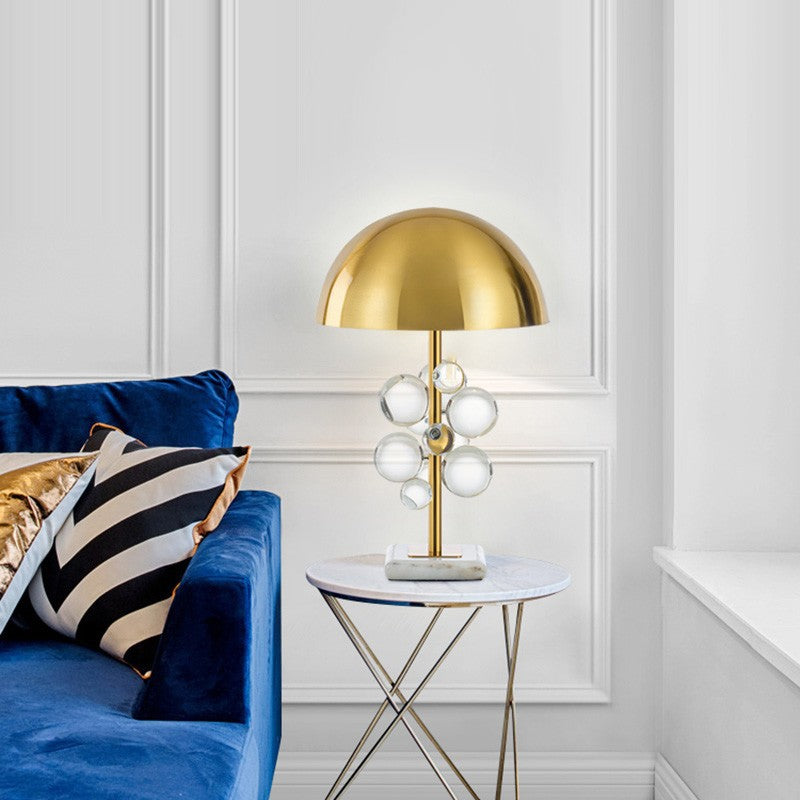 Illuminated brass table lamp with blue velvet sofa