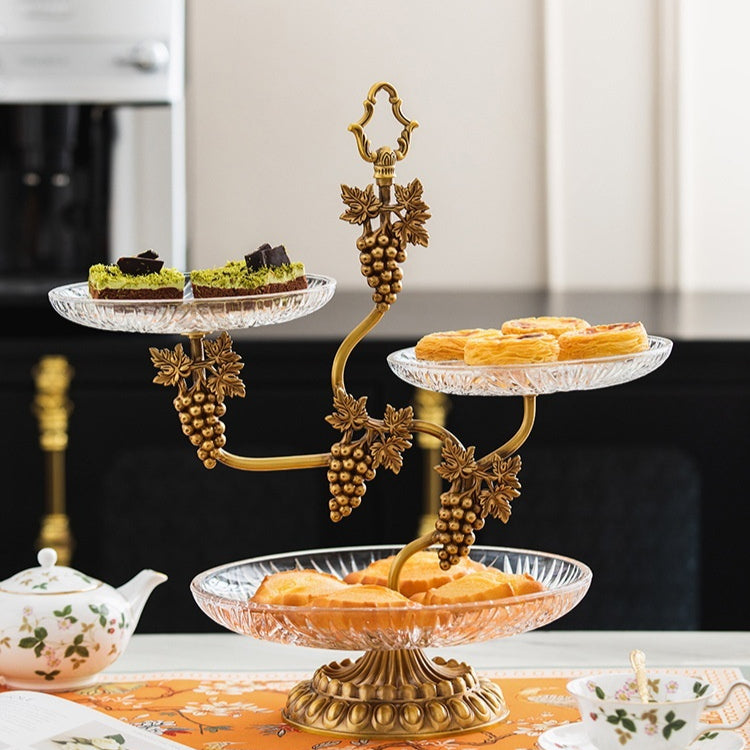 Front view of brass and glass 3-tier serving stand with pastries