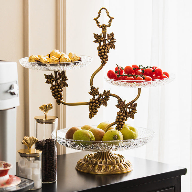 Detail of grapevine brass motif with fruit on glass tiers
