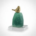 Brass and green stone bird figurine on a clear base