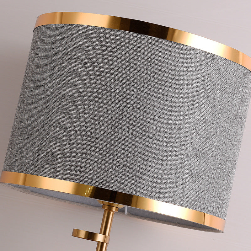 Close up of the grey fabric shade with gold trim