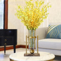 Brass and marble vase on coffee table with yellow flowers