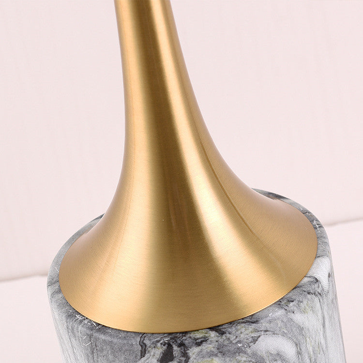 Close up of tapered gold stem and green velvet lampshade