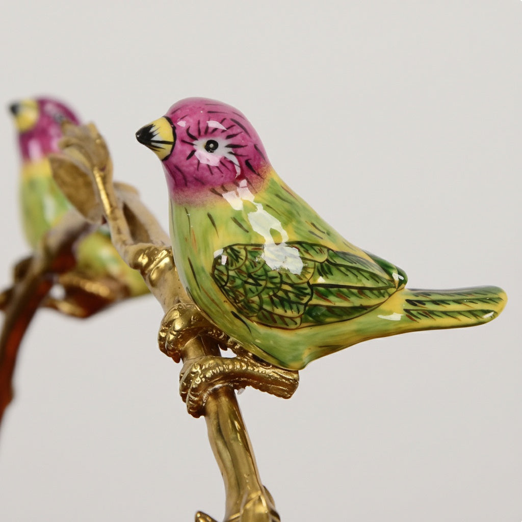 Detail shot of colorful ceramic bird perched on brass branch