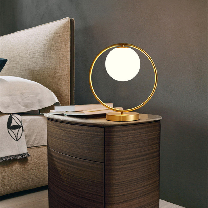 Luxury brass bedside lamp on nightstand in bedroom setting