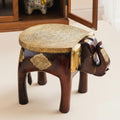 Front angle view of brass and wood elephant stool