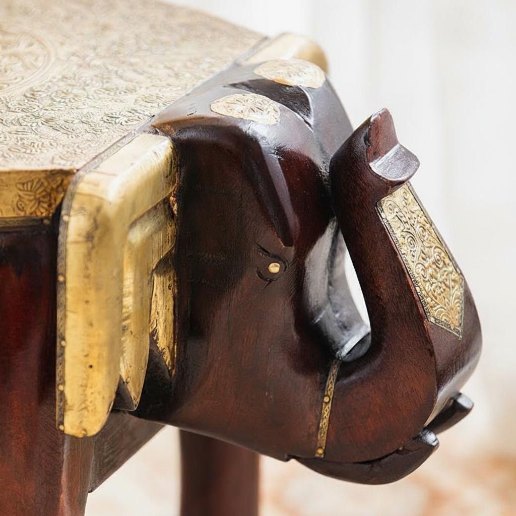 Detail of carved wood head and brass ear accents
