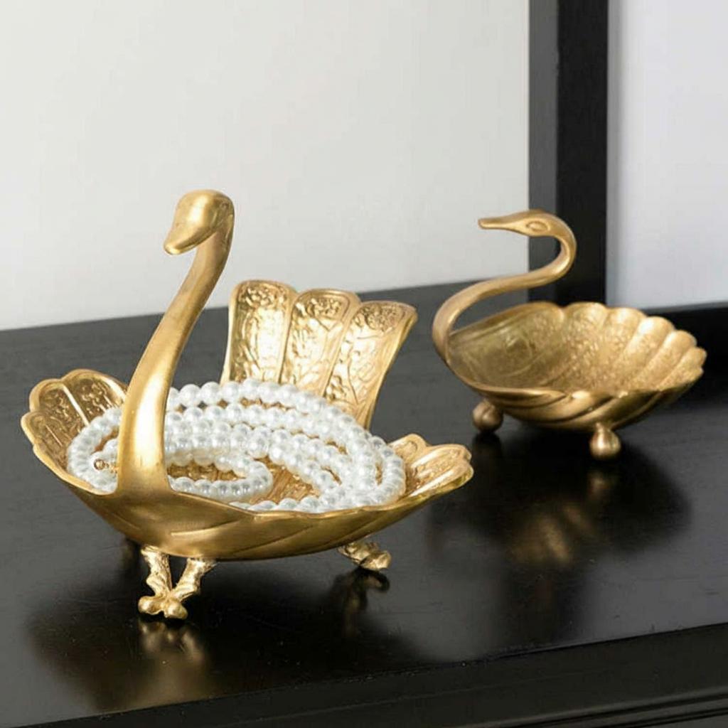 Brass swan decorative bowls holding pearls and jewelry