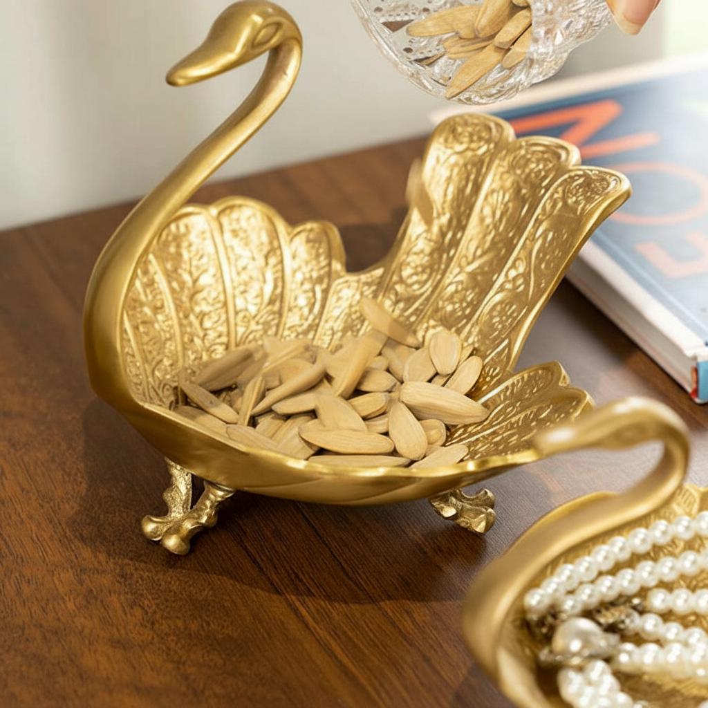 Large brass swan bowl being filled with seeds