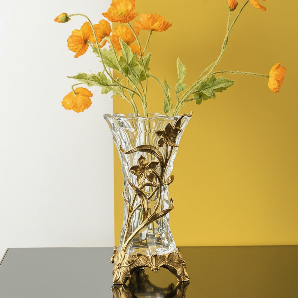 Brass and textured glass vase holding orange flowers lifestyle view