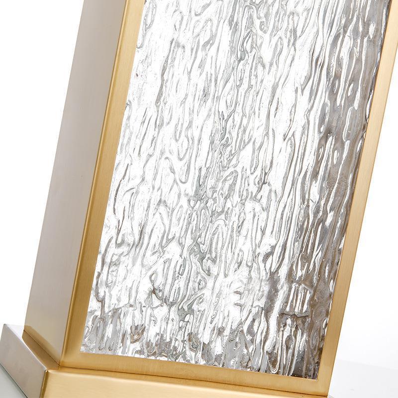 Close up detail of textured water ripple glass and brass frame