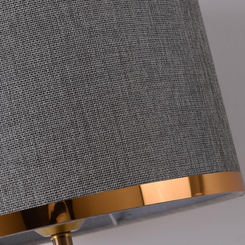 Close up of grey textured fabric shade with gold trim