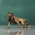 Side profile of brass walking lion figurine on reflective surface