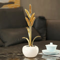 Brass wheat stalk sculpture front view on table