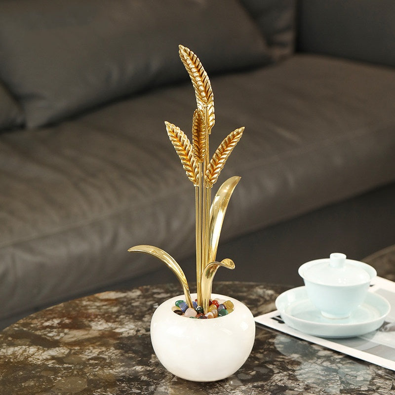 Angled view of brass wheat table ornament
