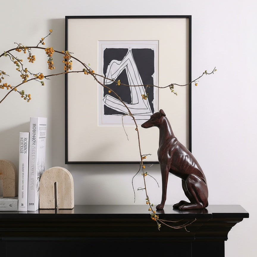 Bronze finish greyhound statue styled on black mantelpiece