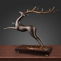 Angled view of bronze deer statue with golden antlers
