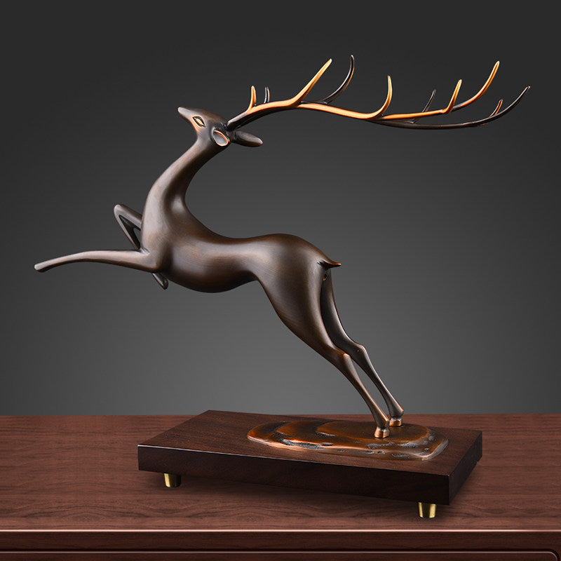 Angled view of bronze deer statue with golden antlers