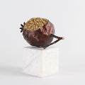 Bronze pomegranate sculpture with gold seeds on marble base