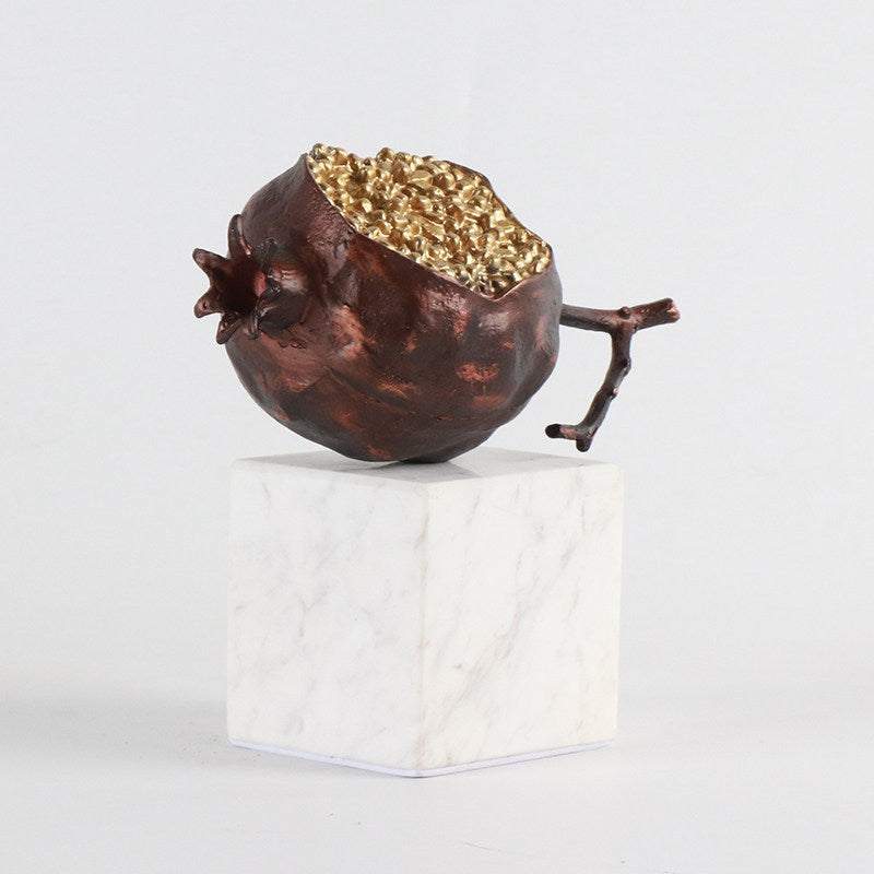 Side view of textured bronze pomegranate decor