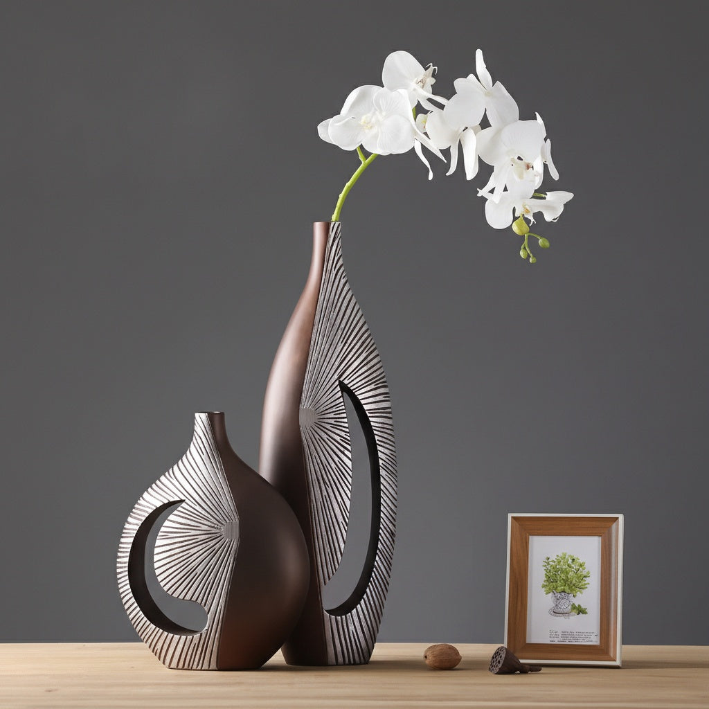 Set of bronze resin abstract vases on wooden table