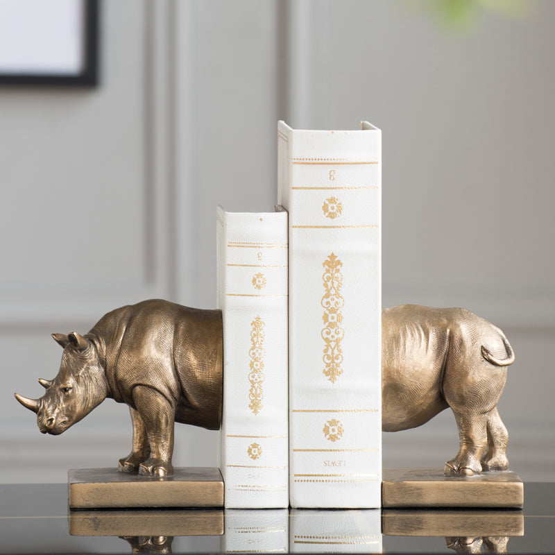 Antique bronze rhinoceros bookends holding books side view