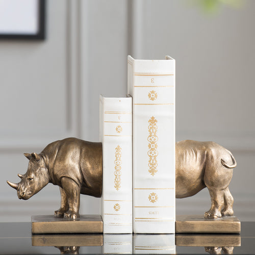 Antique bronze rhinoceros bookends holding books side view