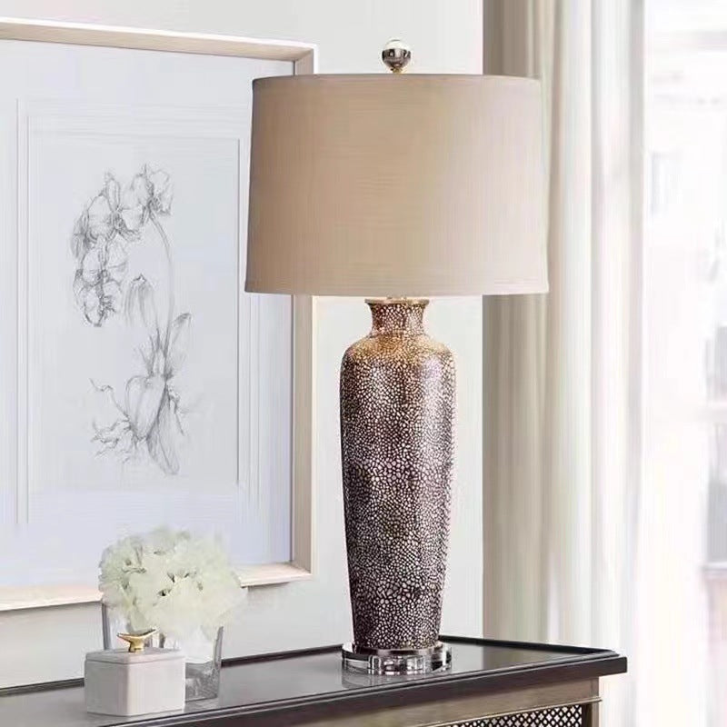 Context view of bronze ceramic lamp on console table