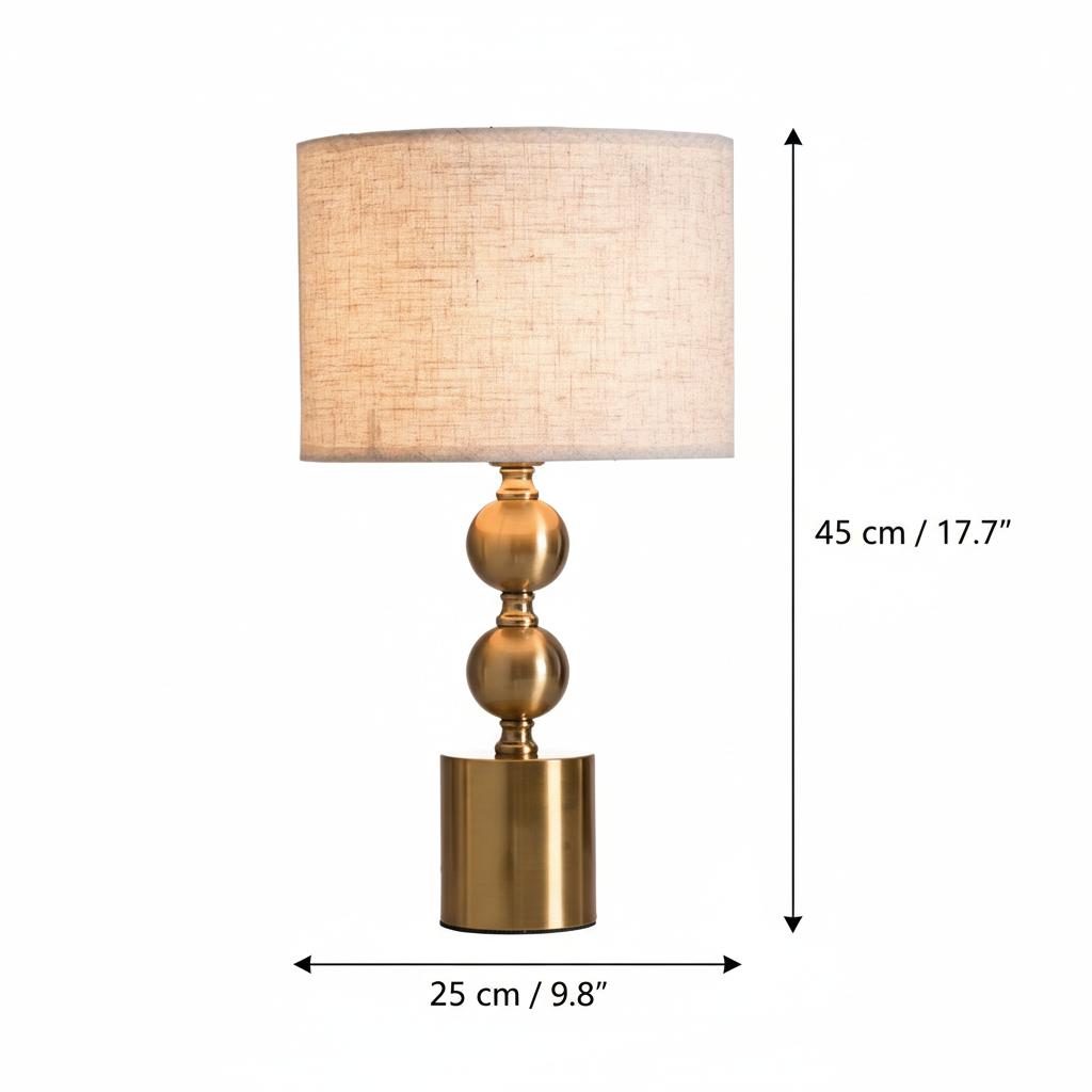 Lifestyle setting of brass orb table lamp on desk with books