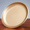 Tilted view of brushed brass pedestal bowl showing interior