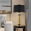 Brushed gold and black cylindrical table lamp front view