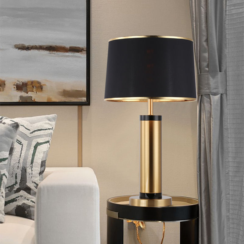 Brushed gold and black cylindrical table lamp front view
