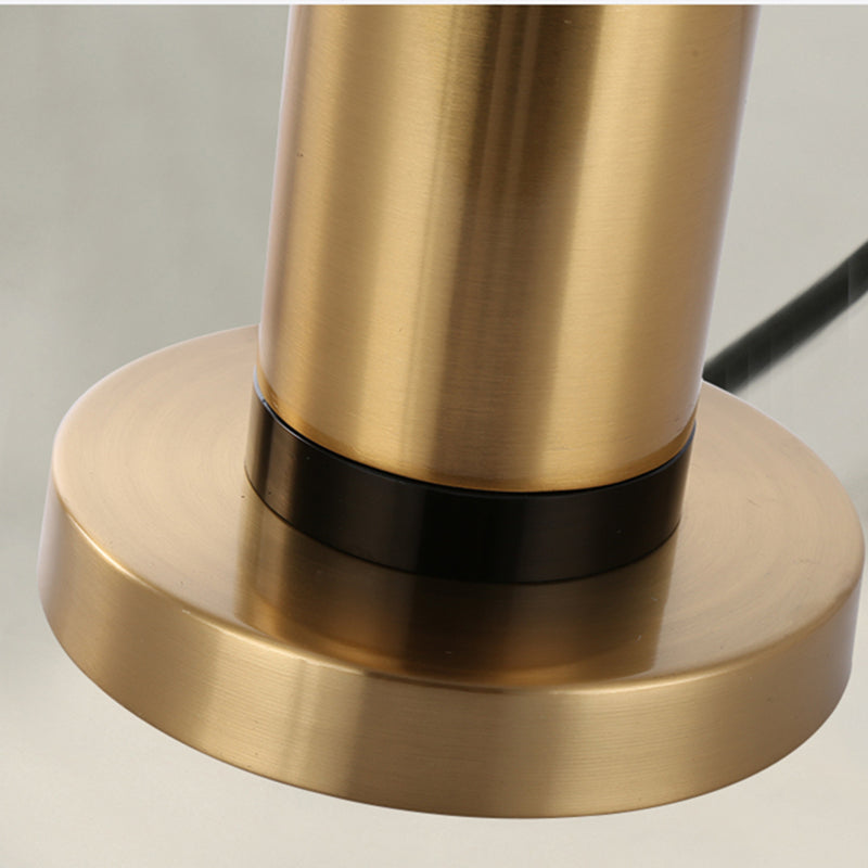 Detail of brushed gold lamp base and column