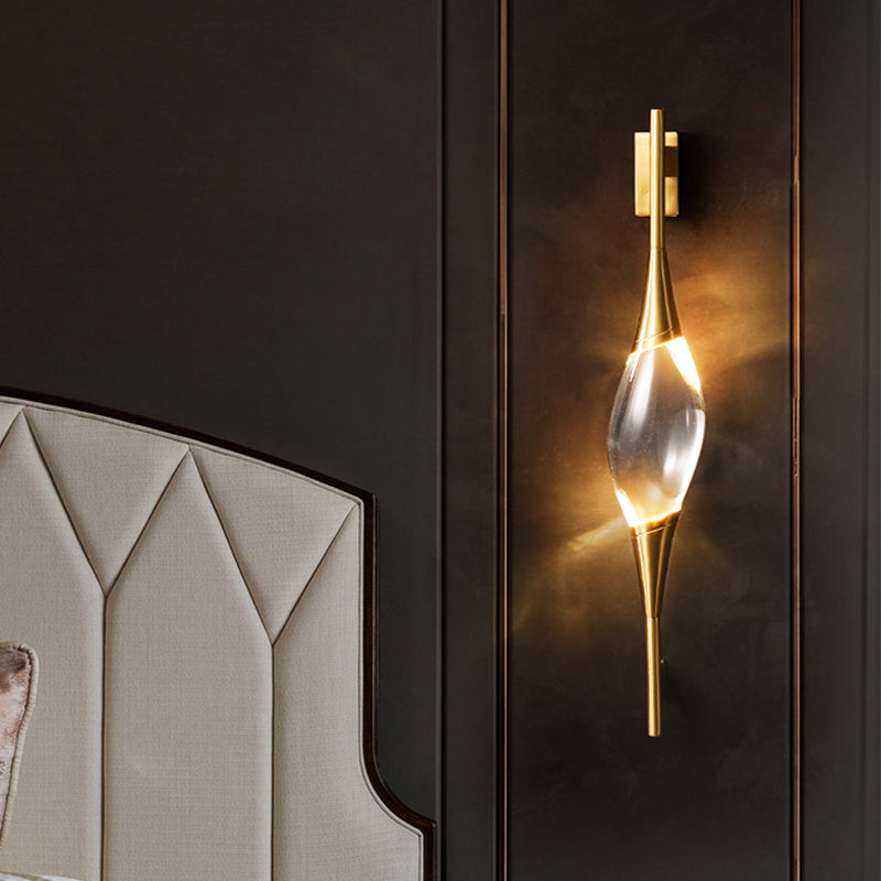 Angled view of the sconce installed on a dark paneled wall