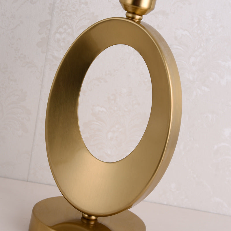 Detail view of oval gold metal lamp base loop