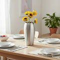 Brushed Stainless Steel Tapered Vase styled with sunflowers on a dining table