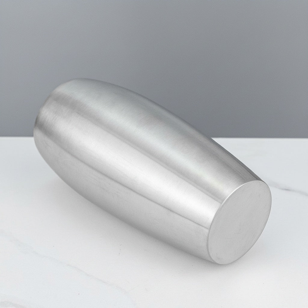 Brushed Stainless Steel Tapered Vase resting on its side showing the solid base