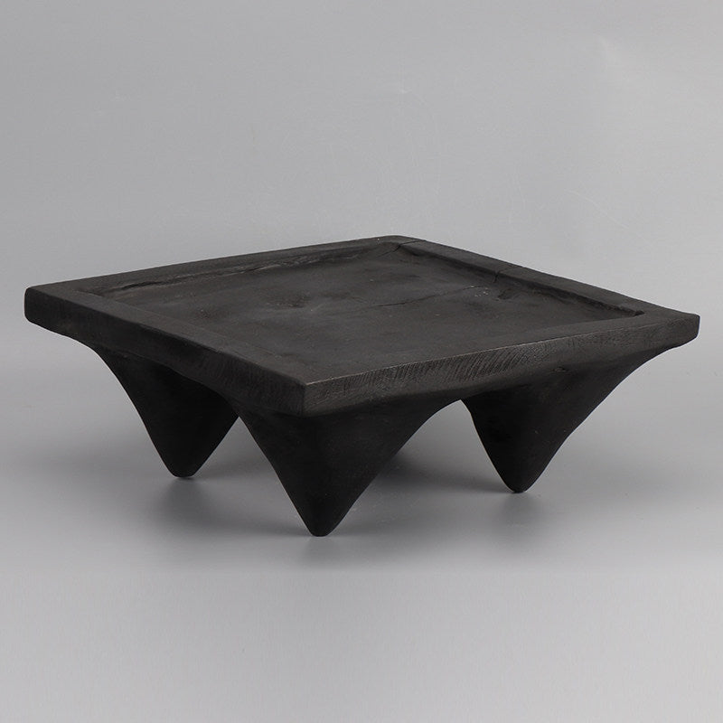 Carbonized wood square pedestal tray with conical legs angled view