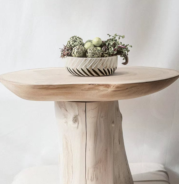 Distant view of wooden fruit bowl on rustic table