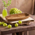 Carved wood elongated centerpiece bowl styled with fresh green apples