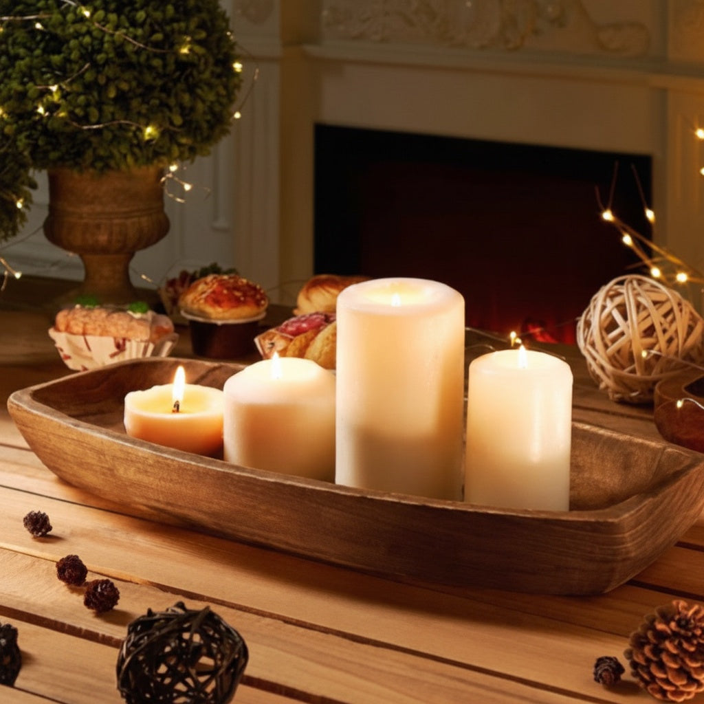 Carved wood elongated centerpiece bowl illuminating a table with pillar candles