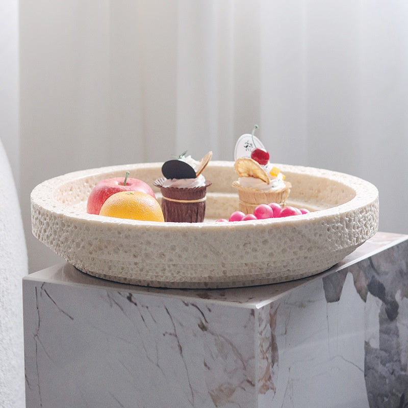 Side view of textured stone tray on marble plinth